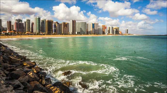 Aquamarine waves meet the shore at Mucuripe Beach, Fortaleza Brazil.